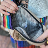 A woman holding the Bohemian Round Print Cotton Crossbody Bag open, showing off the inside.