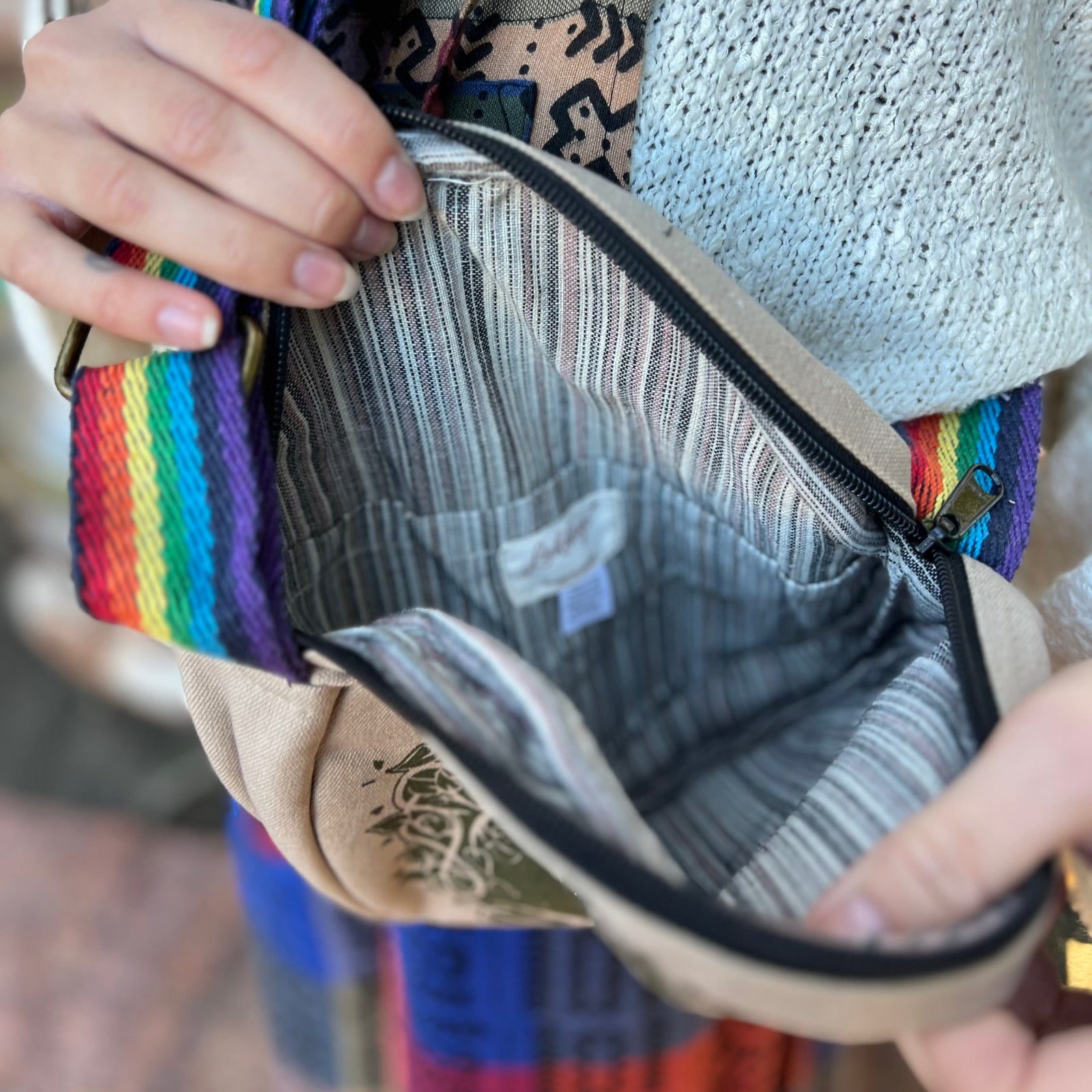 A woman holding the Bohemian Round Print Cotton Crossbody Bag open, showing off the inside.