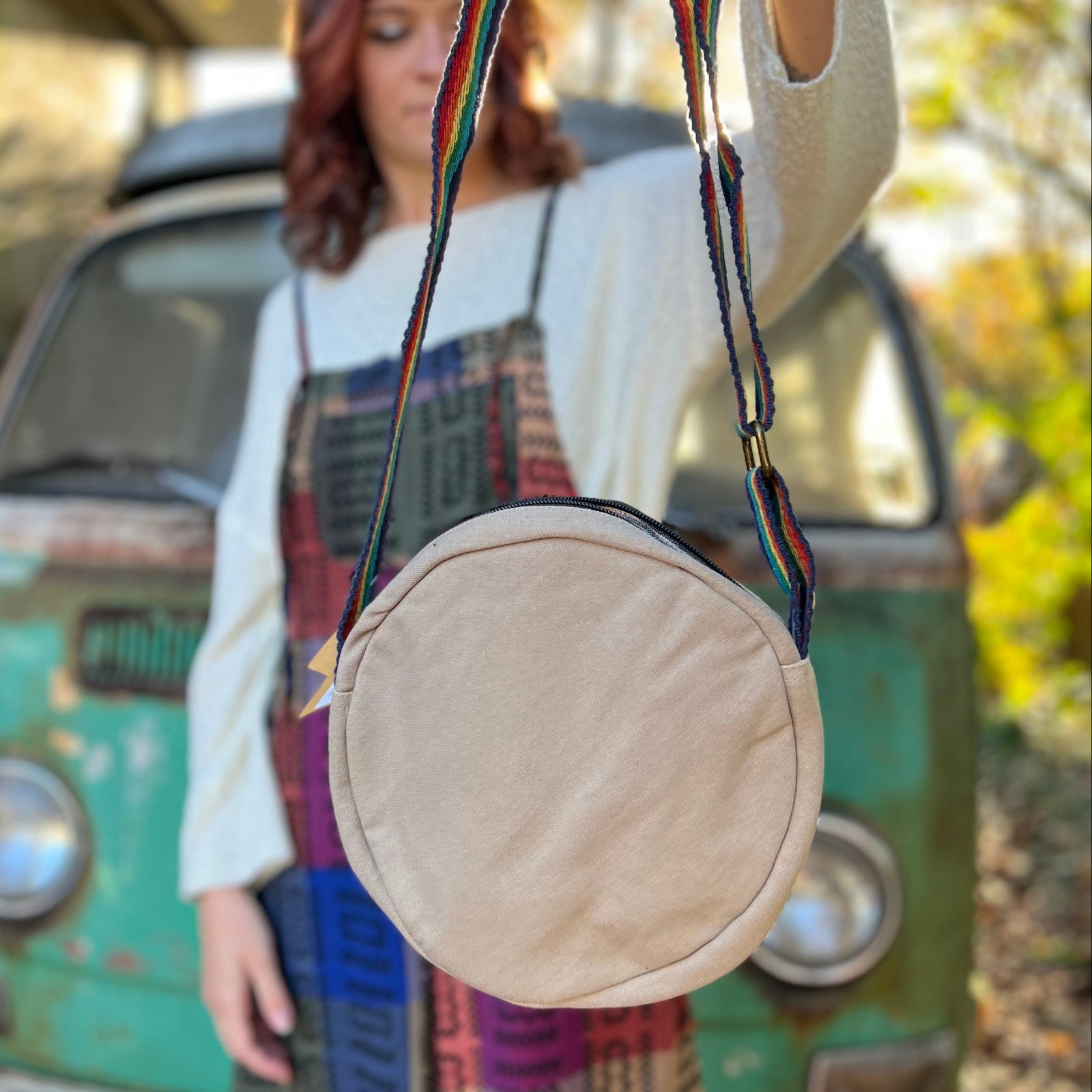 A woman holding the Bohemian Round Print Cotton Crossbody Bag, showing off the back.