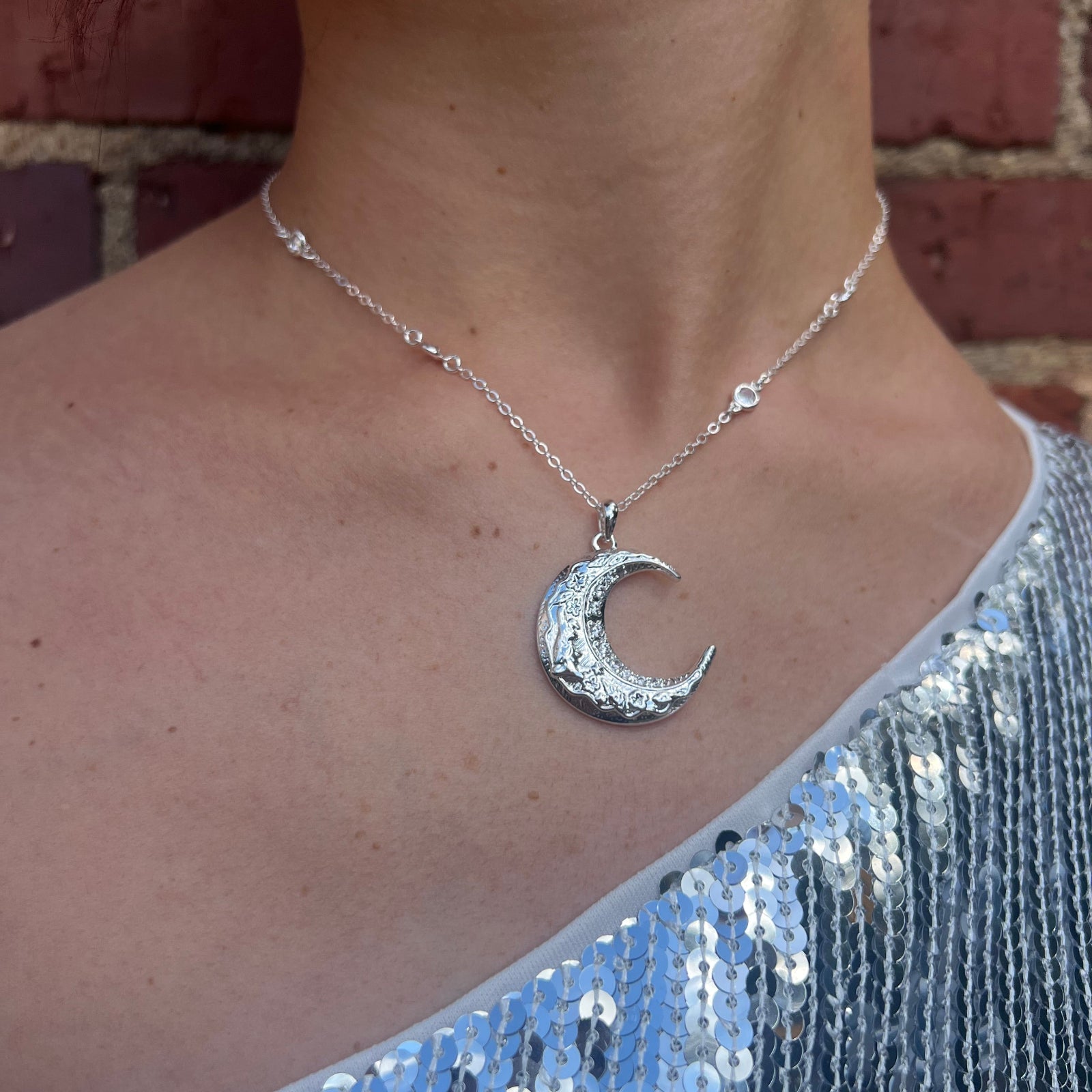 Someone wearing the The Hare Moon Silver Necklace.