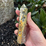 Pyrite Crystal Obelisk Tower in front of a mulch bed