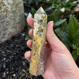 Pyrite Crystal Obelisk Tower in front of a mulch bed