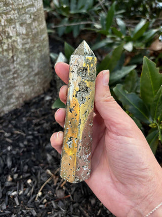 Pyrite Crystal Obelisk Tower in front of a mulch bed