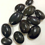 Glossy rainbow obsidian crystals showcasing deep green and purple iridescence