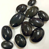 Glossy rainbow obsidian crystals showcasing deep green and purple iridescence