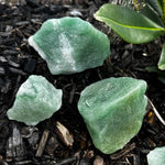 rough green aventurine laying in dirt