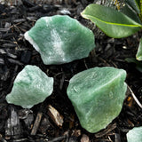 rough green aventurine laying in dirt