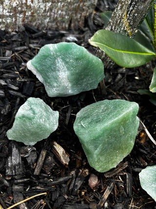 rough green aventurine laying in dirt