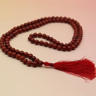 Red Jasper 108 Mala Necklace on pink and orange background