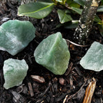 rough green aventurine laying on ground