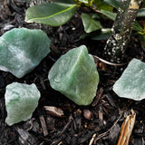 rough green aventurine laying on ground