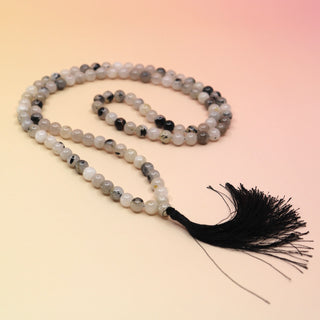 Rutile Quartz 108 Mala Necklace on pink and orange background