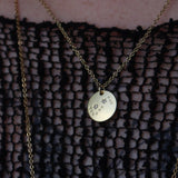 Someone wearing the Scorpio 14k Gold Dipped Nickel-Free Zodiac Necklace with a black net top.