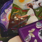 The cards of the Seasons of the Witch - Litha Oracle Card Deck with crystals around them.