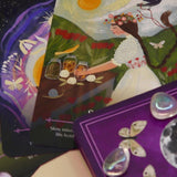 The cards of the Seasons of the Witch - Litha Oracle Card Deck with crystals around them.