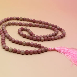 Thulite 108 Mala Necklace on pink and orange background