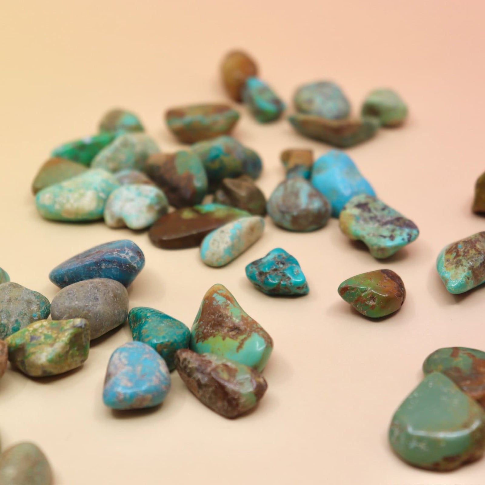 Collection of turquoise stones on a beige background