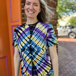 front view of model wearing a blue purple and yellow diamond patterned tie dye tshirt
