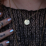 Someone wearing the Sagittarius 14k Gold Dipped Nickel-Free Zodiac Necklace with a black net top.