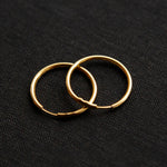The gold Vintage Endless Hoops Earrings on a black background