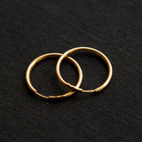 The gold Vintage Endless Hoops Earrings on a black background