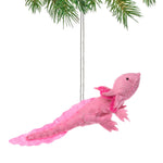Pink axolotl ornament hanging from a branch on a white background