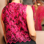 A woman wearing the Embellished Sequin Scallop Crop Top with a black skirt, showing off the back.
