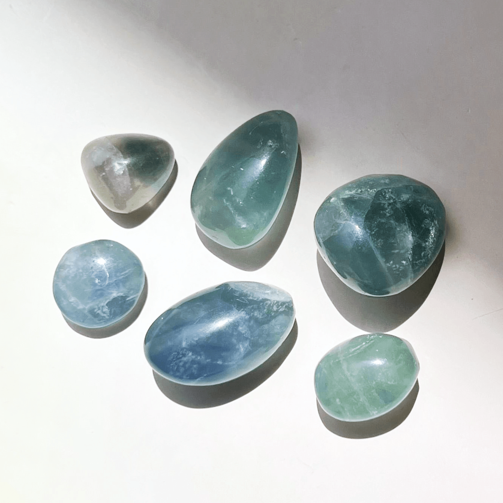 Blue and green fluorite crystal tumble stones polished with natural color variations for clarity and focus