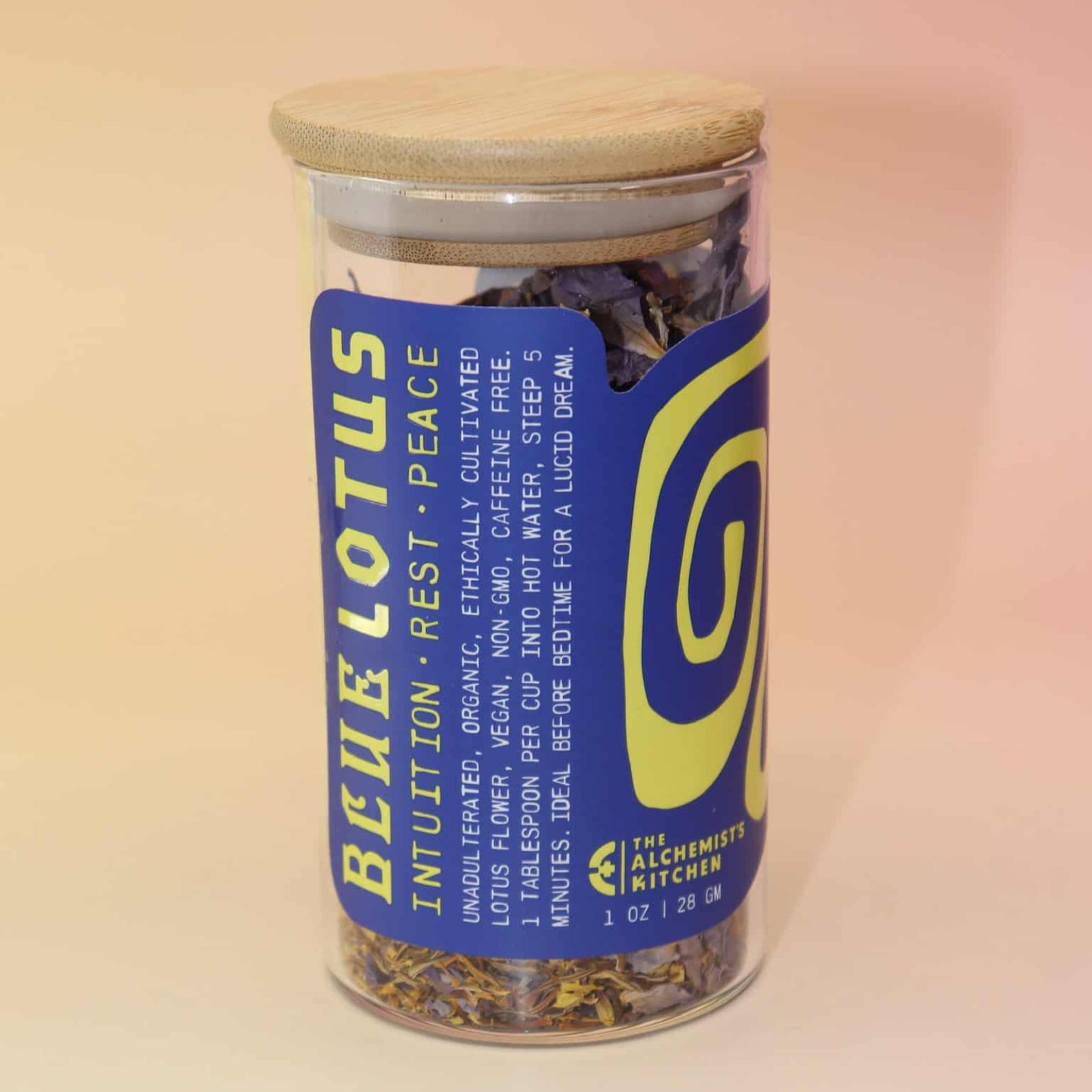 Egyptian Blue Lotus Flower Tea with whole purple petals and golden stamens spilling from jar.