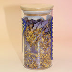 Loose Blue Lotus Flower Tea with deep blue-purple petals on soft neutral background.