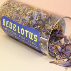 Glass jar of organic Blue Lotus Tea with bamboo lid, labeled for intuition, rest, and peace.