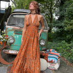 Woman twirling in flowy silk bohemian maxi dress