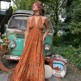 Woman twirling in flowy silk bohemian maxi dress