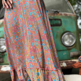 Woman twirling in flowy hippie boho maxi silk dress