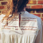 back view of boho chic mock neck top with keyhole closure in natural hue