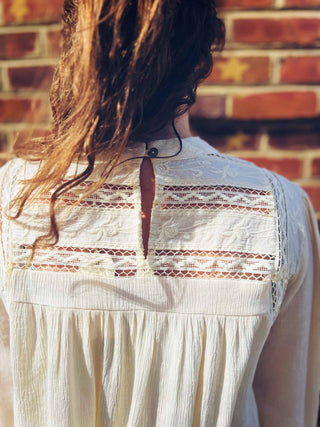 back view of boho chic mock neck top with keyhole closure in natural hue