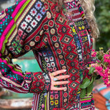 Button closure detail of cotton boho festival unisex trench coat