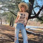 Boho western outfit with Hold Your Horses graphic tee styled with hat and denim