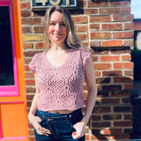boho cotton crochet sweater top styled with cute hippie jeans in front of the boho depot store front