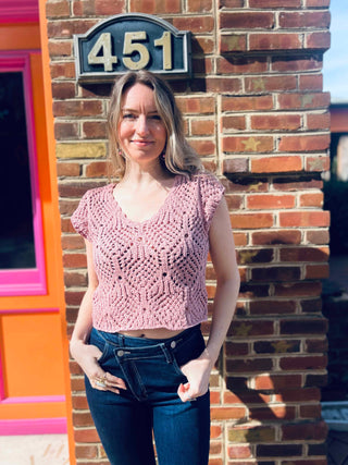 boho cotton crochet sweater top styled with cute hippie jeans in front of the boho depot store front