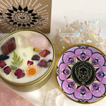 The Leo Crystal Candle opened with the lid to the right of it. The packaging of the Leo Crystal Candle is behind the candle next to a card.