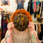 Chocolate opal gemstone lion head carving with rich brown coloring, natural orange streaks and a polished finish