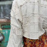 Back view of bohemian grunge bell sleeve crop top
