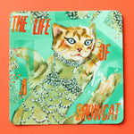 Sticker with a cat illustration and text 'The Life of a Showcat' on a colorful background