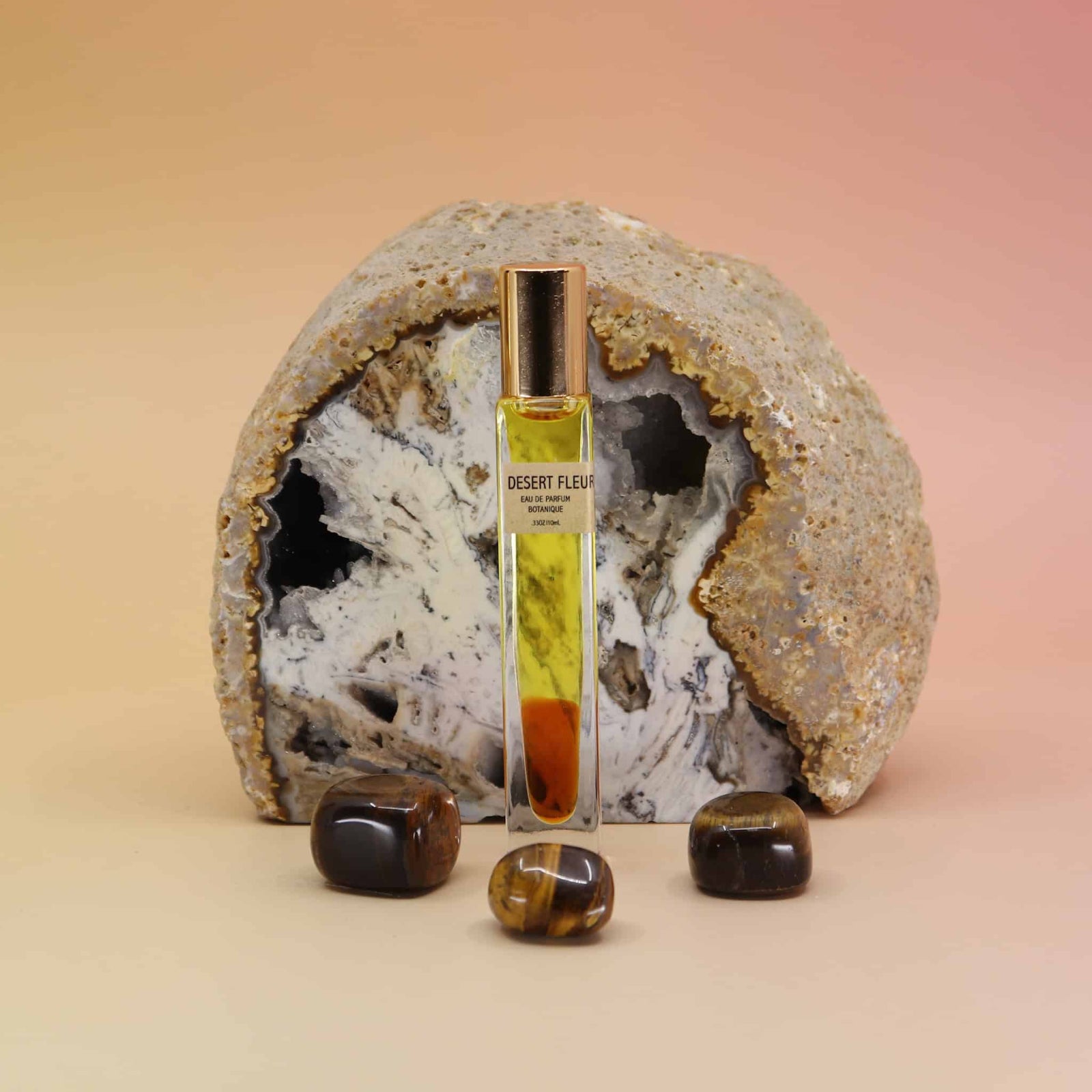 Desert Fleur Botanical Perfume rollerball – 10ml with tiger’s eye stones and geode background