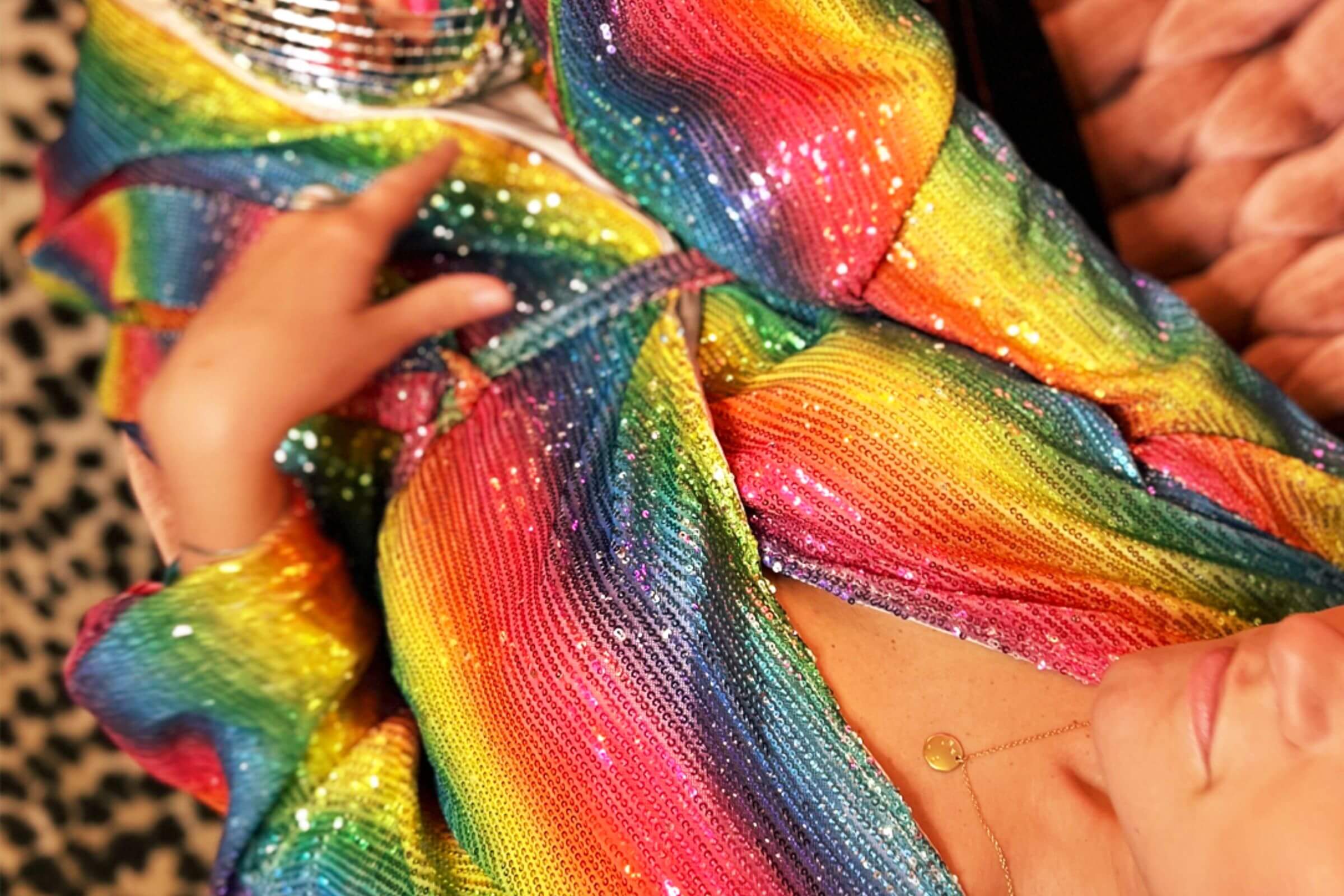 Woman wearing a retro 70s disco outfit with platform heels in a boho-inspired living room