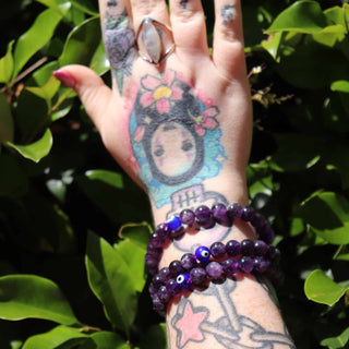 Wrist shot of Amethyst beaded bracelet with evil eye