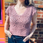 woman wearing a crochet knit v neck cap sleeve top 