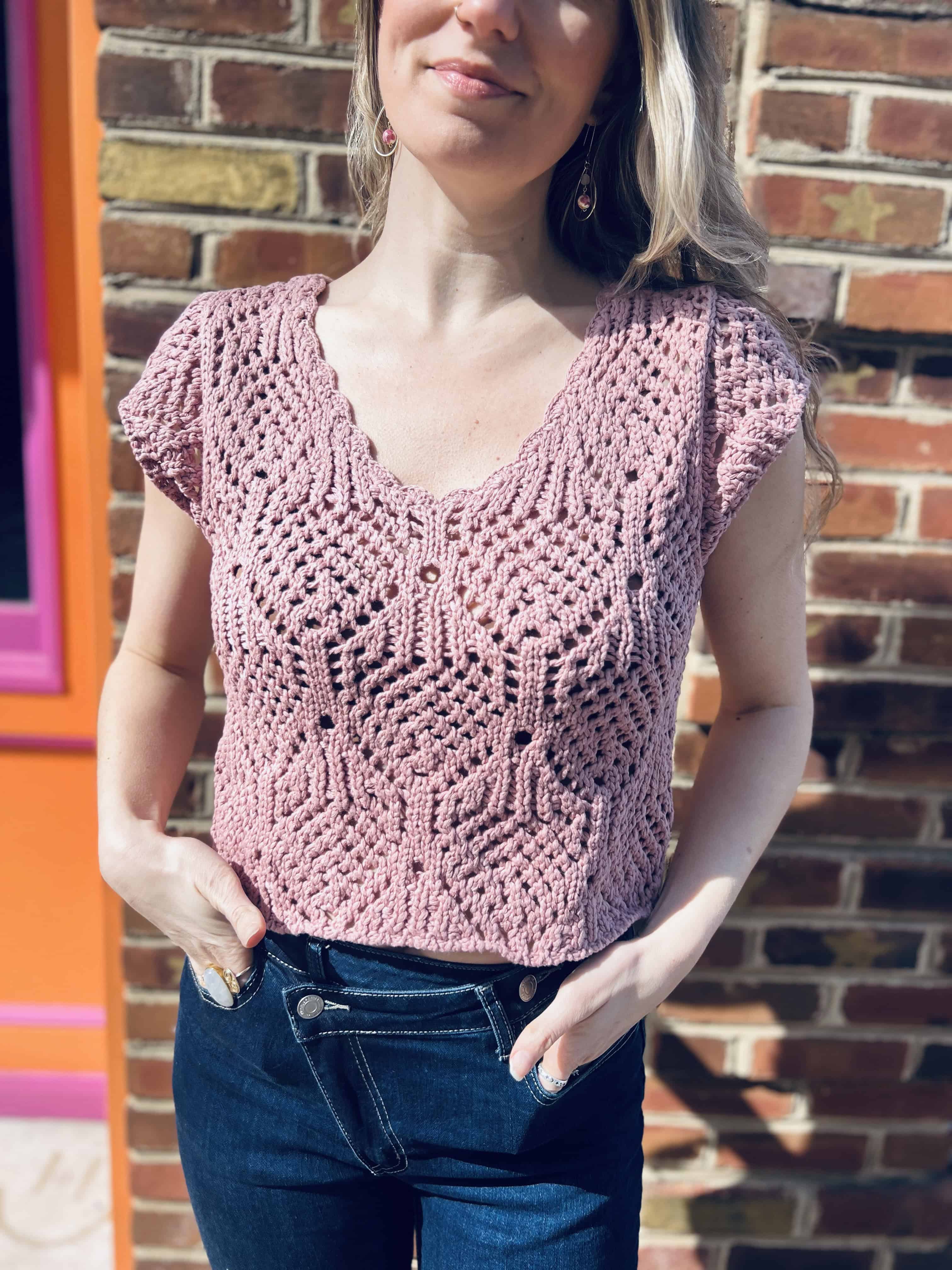 woman wearing a crochet knit v neck cap sleeve top 