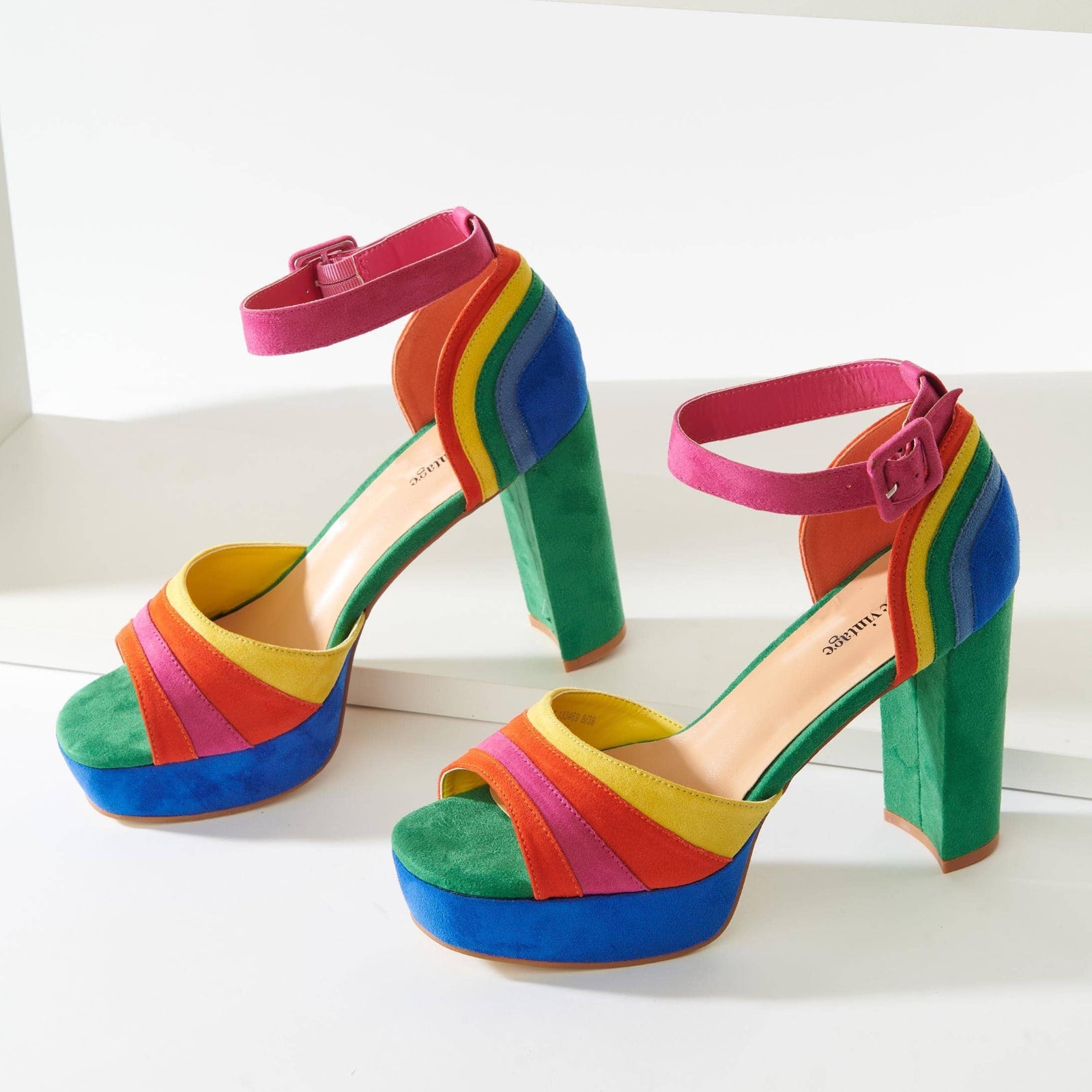 A pair of colorful suede peep toe pumps with adjustable ankle straps and a 4.5 inch heel.